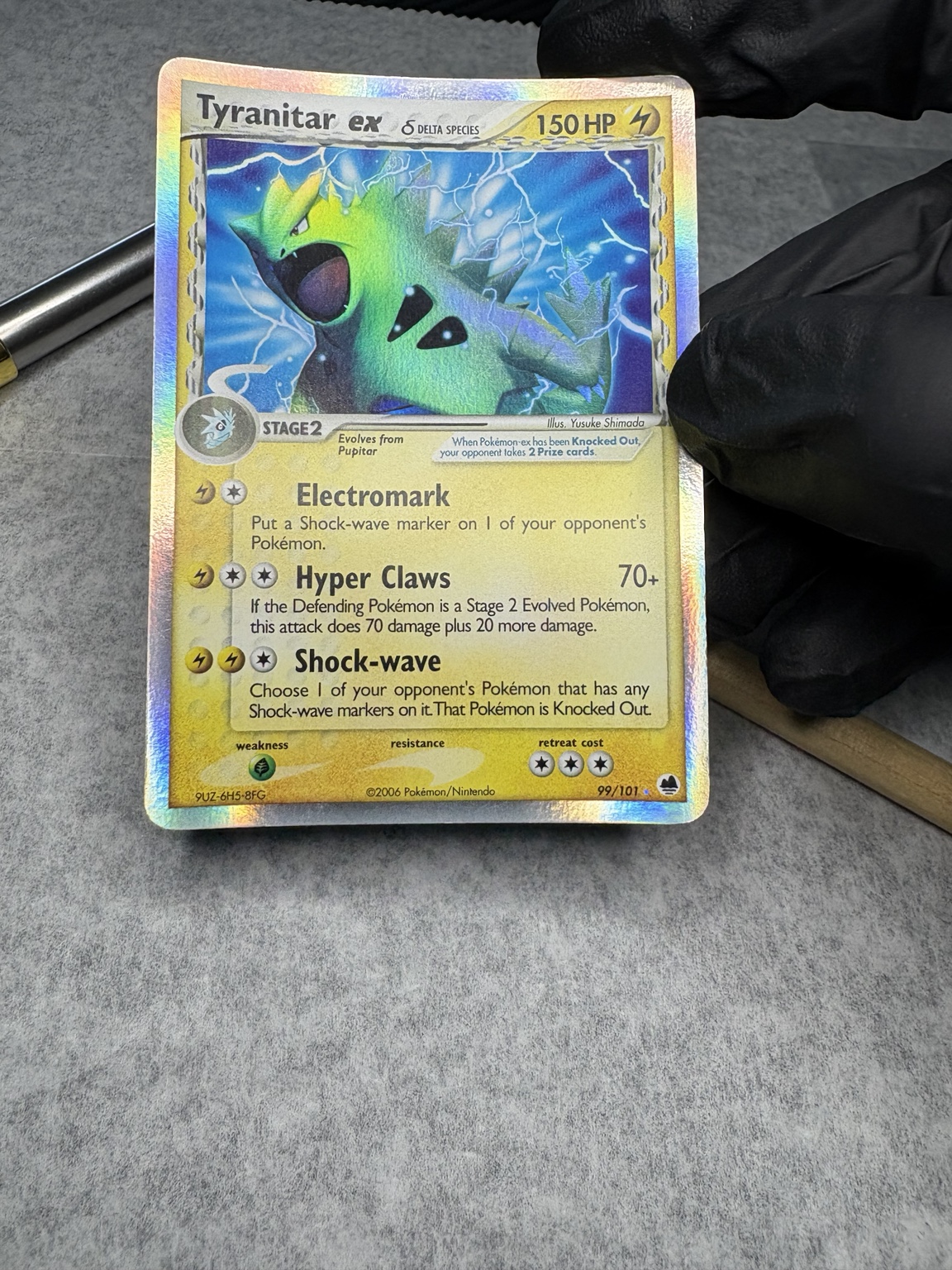 Warped Tyranitar ex card front before restoration